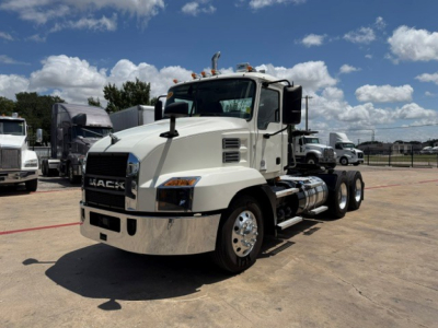 Mack AN64T daycab tractor in white with chrome front bumper and fuel tanks visible.