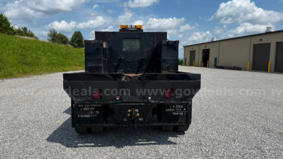 Vehicle rear view of a 2007 International 4300 flatbed truck showing rear bumper, taillights, and truck bed with warning lights.