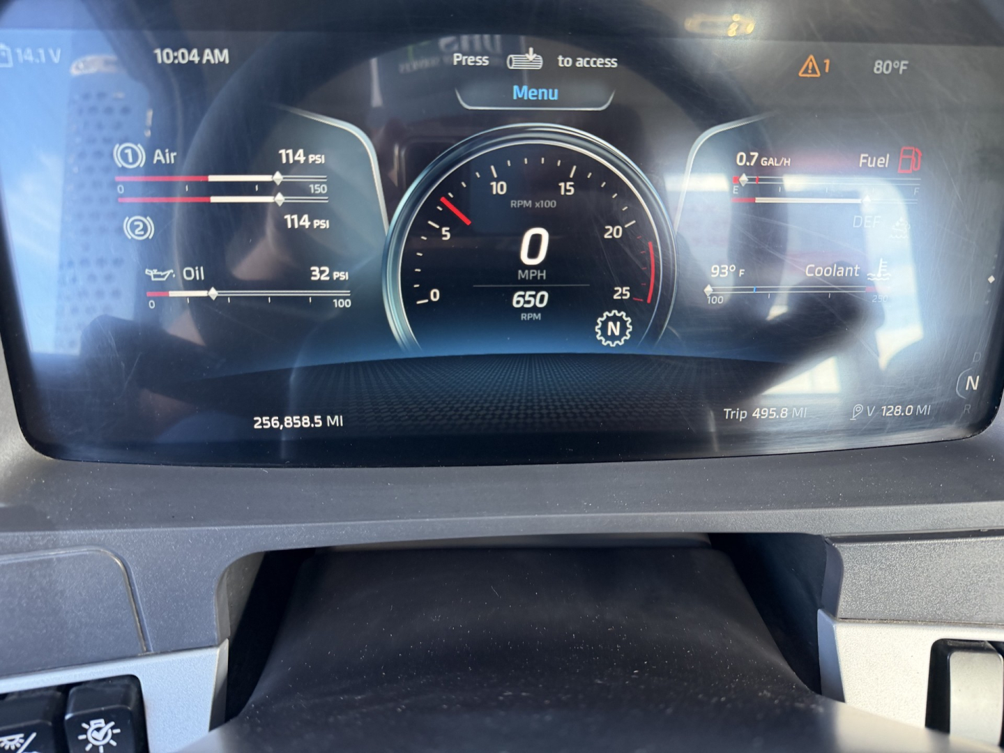 Dashboard of a 2023 Kenworth T880 showing digital gauges: RPM/Speed, fuel and coolant indicators, and mileage readouts.