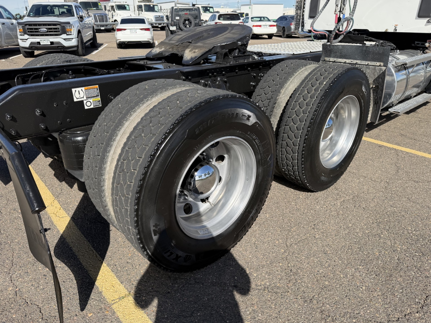 Kenworth T880 chassis with dual rear axles and tires visible, truck bed area, VIN and stock information not shown in this shot.