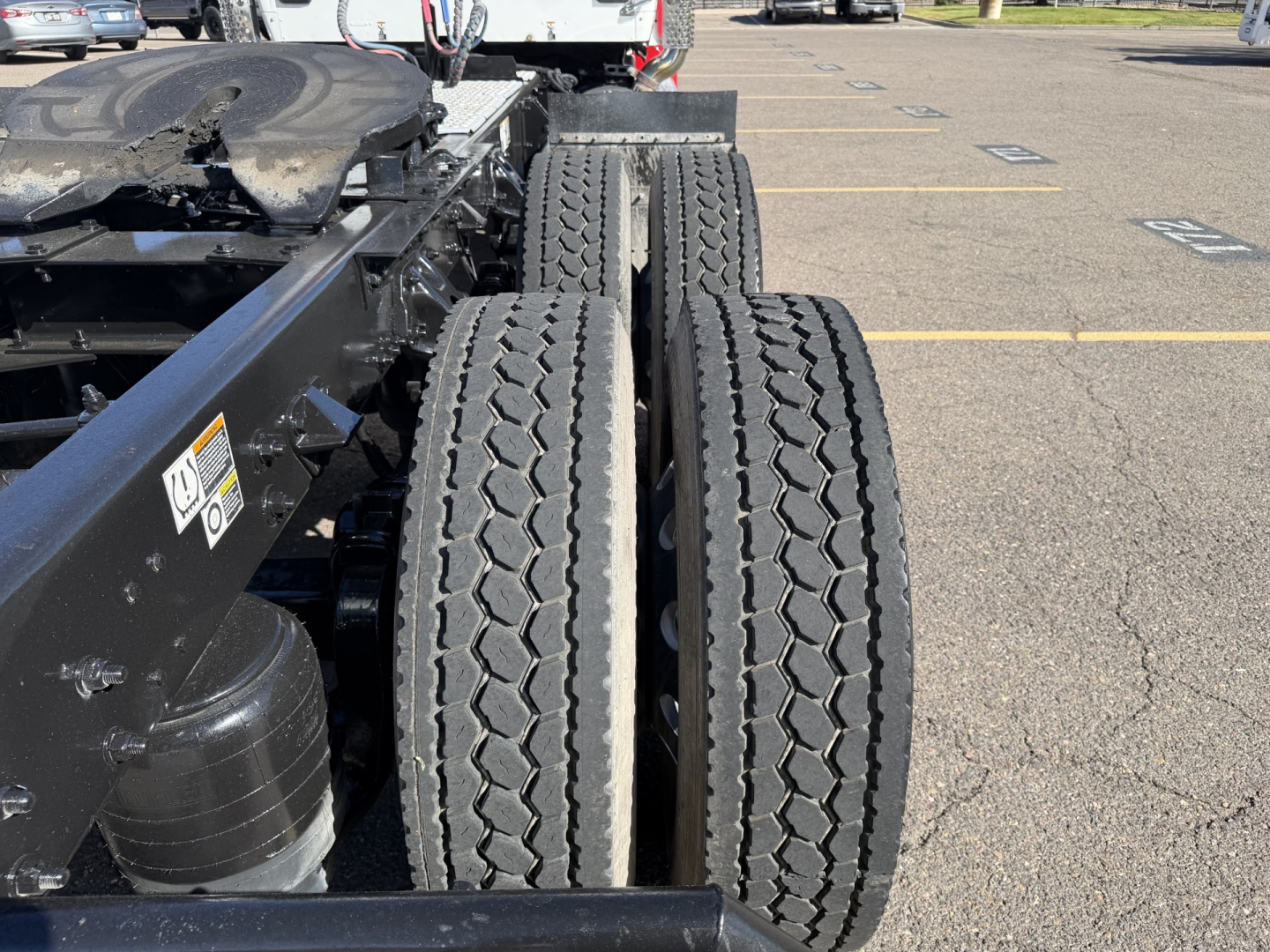 Kenworth T880 chassis with dual rear wheels and tires visible in the truck yard.