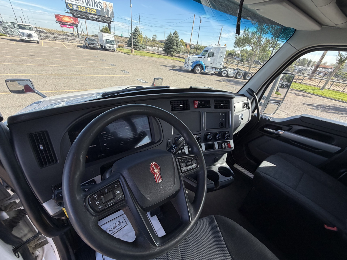 Kenworth T880 cab interior with steering wheel and dashboard, stock number 0632142, seen from driver seat.