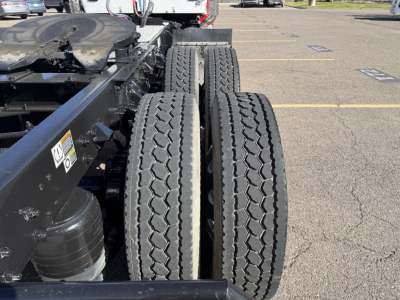 Kenworth T880 chassis with dual rear wheels and tires visible in the truck yard.