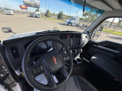 Kenworth T880 cab interior with steering wheel and dashboard, stock number 0632142, seen from driver seat.