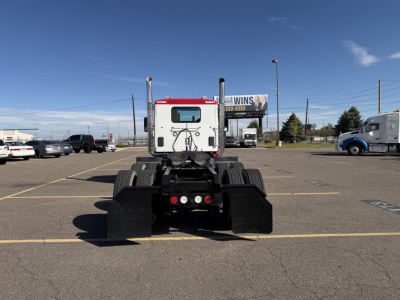 Kenworth T880 rear view showing chassis and dual rear axles with mud flaps and taillights.