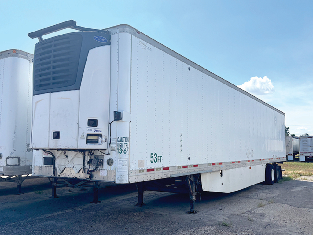 Reefer trailer in a parking lot showing Wabash ArcticLite refrigeration unit at front, VIN plate area, and various labeling on side including '53 ft'.
