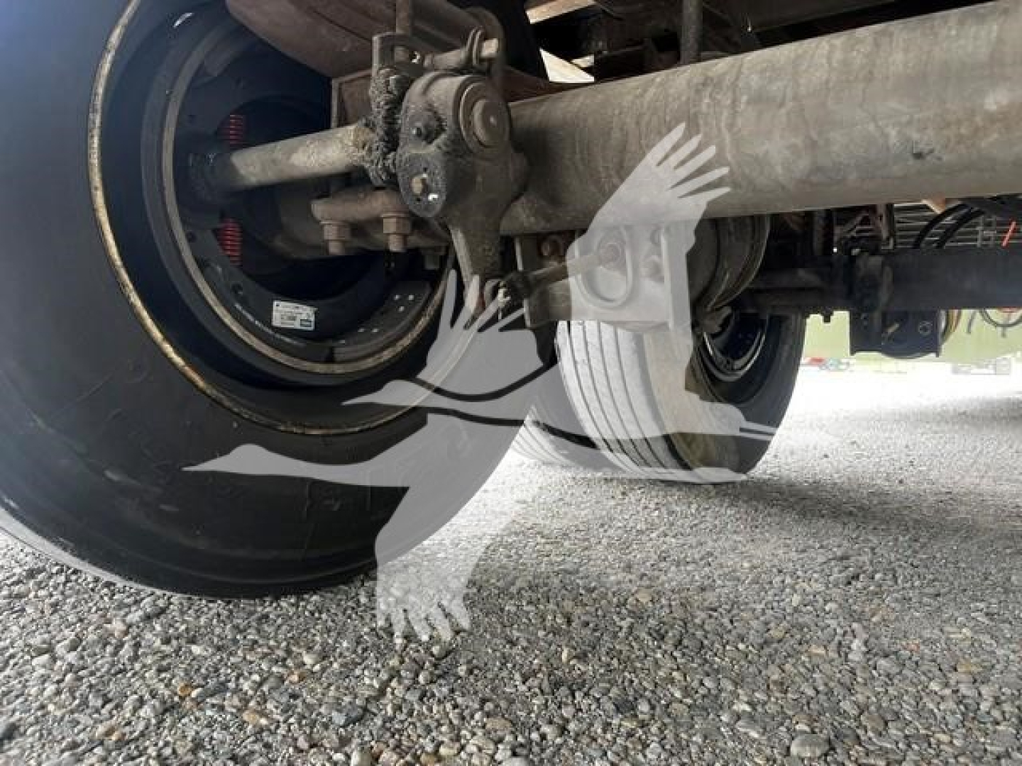 Trailer undercarriage showing wheel and suspension beam of a 2017 Wabash dry van with visible axle and mounting hardware.