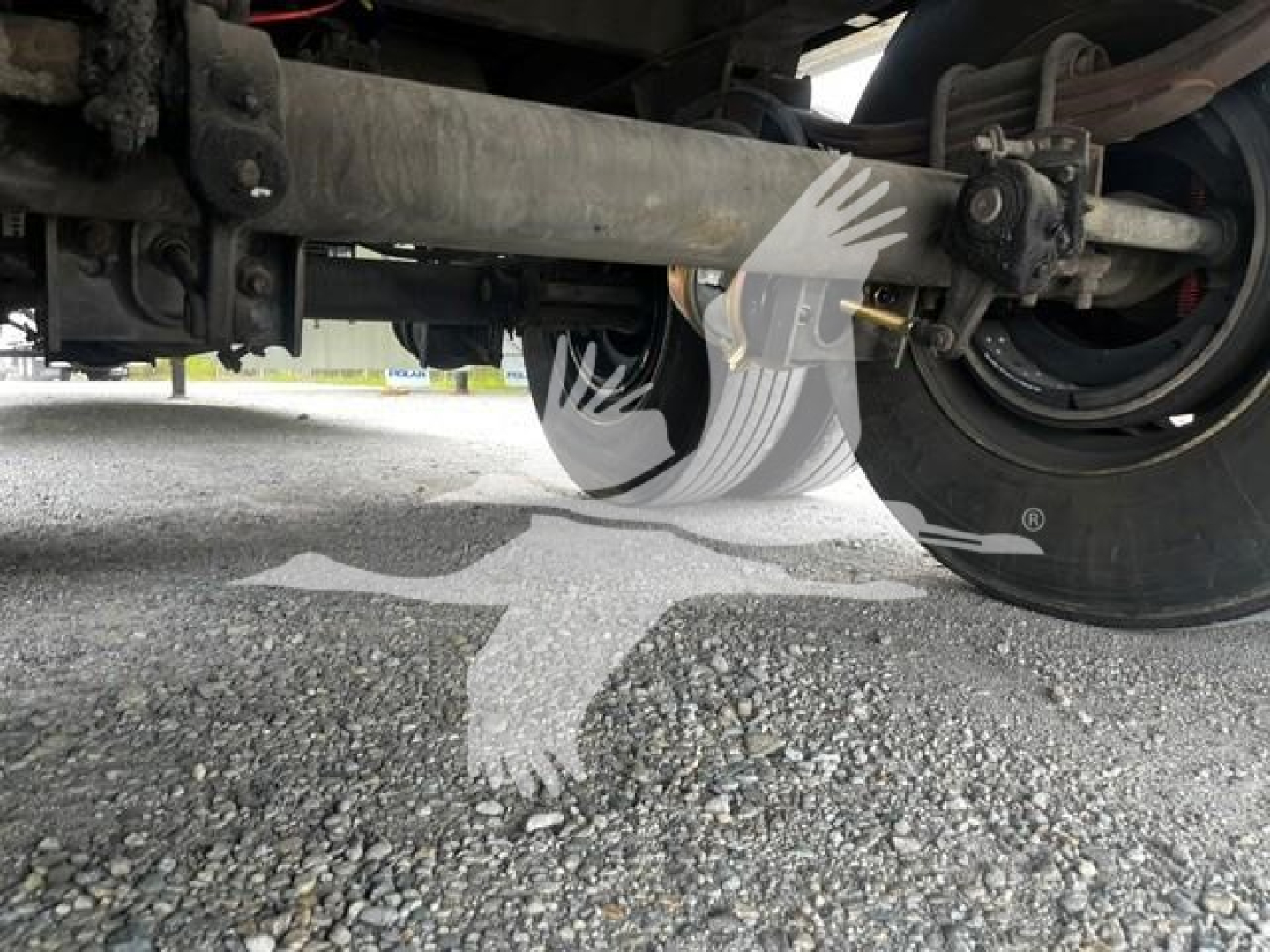 Trailer undercarriage showing wheel, suspension, and frame components of a Wabash dry van trailer.