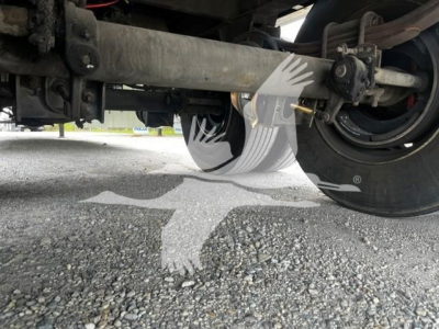 Trailer undercarriage showing wheel, suspension, and frame components of a Wabash dry van trailer.