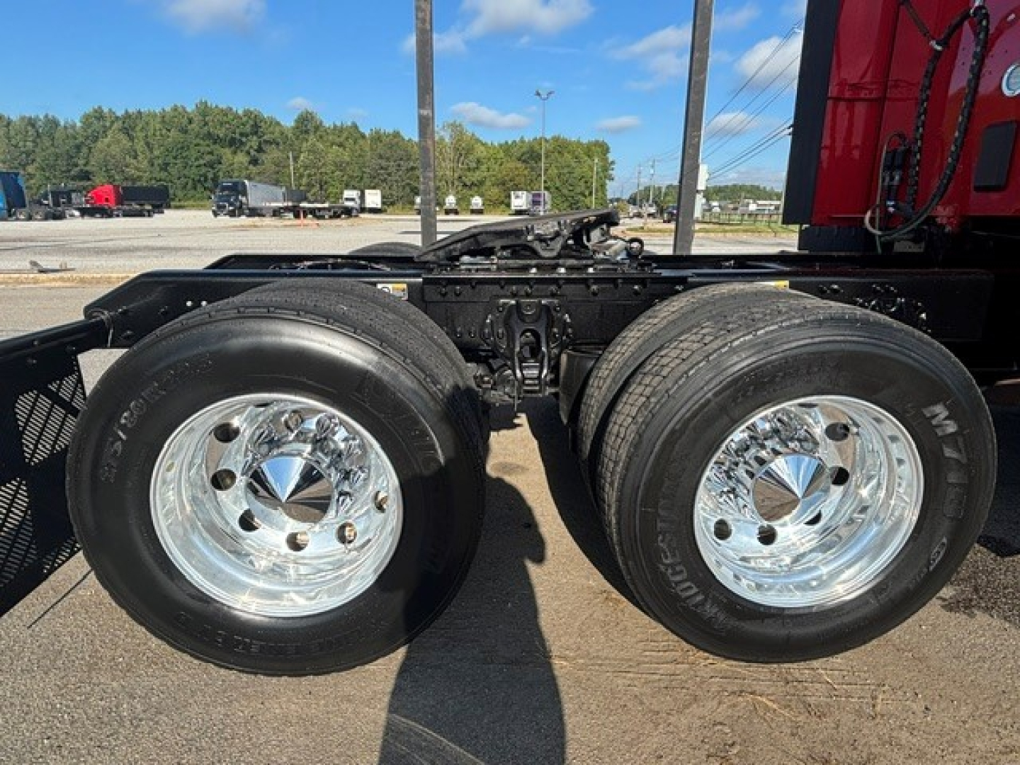 Kenworth T680 chassis with dual rear axles and chrome wheels, visible tires and suspension components.