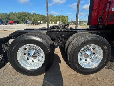 Kenworth T680 chassis with dual rear axles and chrome wheels, visible tires and suspension components.
