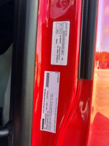 Kenworth T680 door jamb stickers with VIN and serial labels visible.