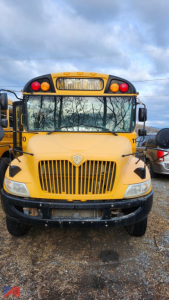 Front view of a yellow 2017 IC Corporation CE Series school bus showing grille, headlights, and windshield with school bus lights overhead.