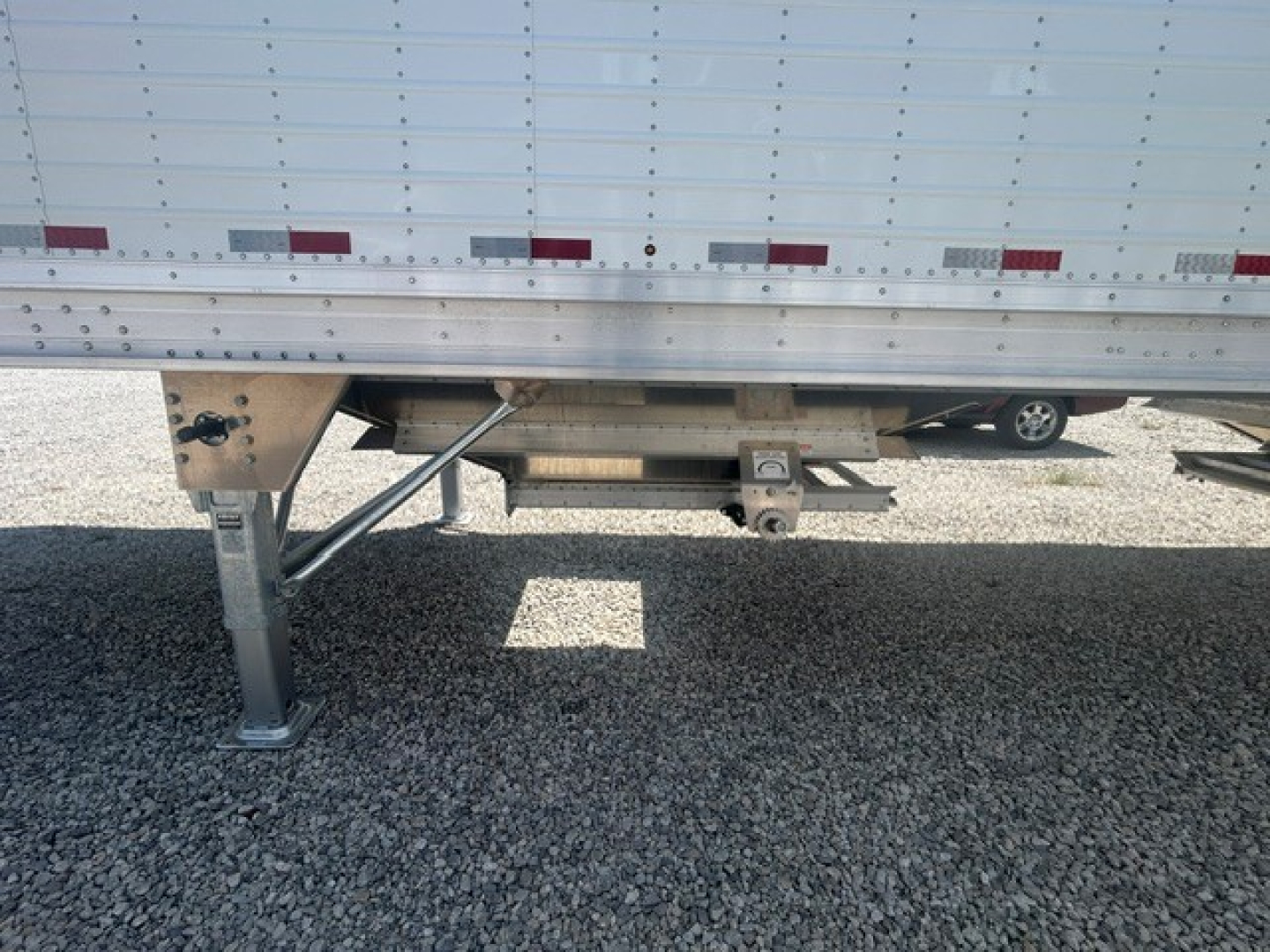 New 2027 Stoughton 40' aluminum grain hopper trailer showing underside legs, landing gear, and corrugated sidewalls with 68-inch height.