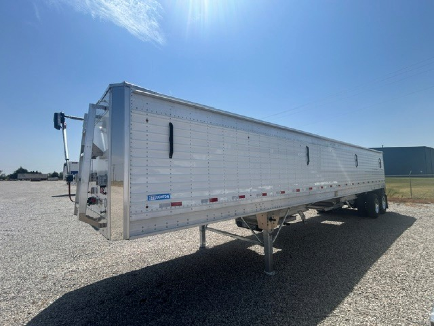 Stoughton aluminum grain hopper trailer with 40' length and 68" corrugated sidewalls, side panels, and landing gear visible.