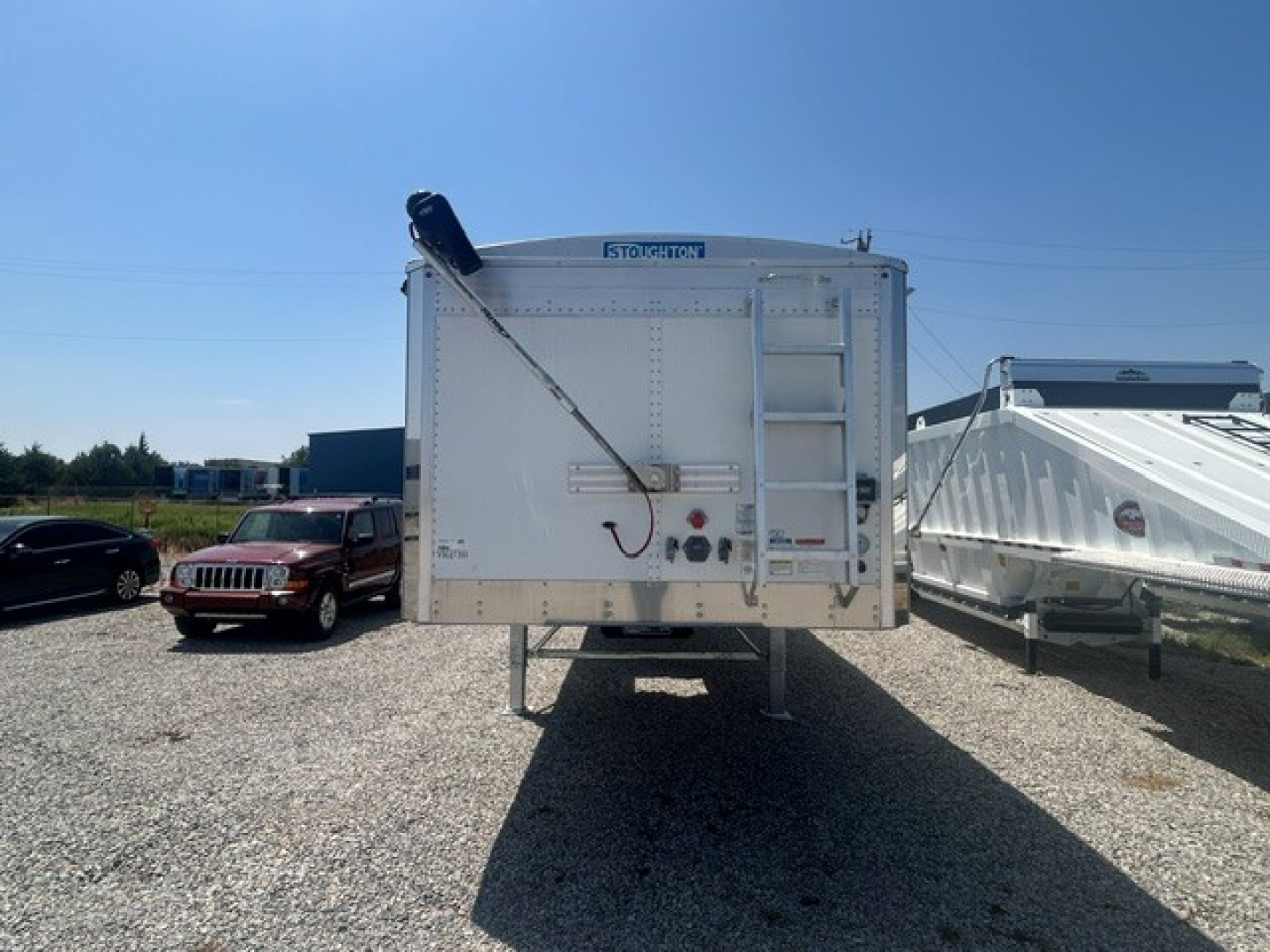 Stoughton hopper trailer back view showing 68" corrugated sidewalls and rear access ladder.