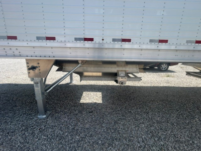 New 2027 Stoughton 40' aluminum grain hopper trailer showing underside legs, landing gear, and corrugated sidewalls with 68-inch height.
