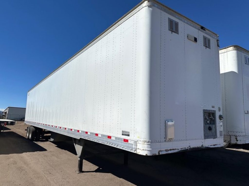 Rear side of a white 2017 Hyundai air ride roll door dry van trailer showing smooth exterior, undercarriage, and landing gear.