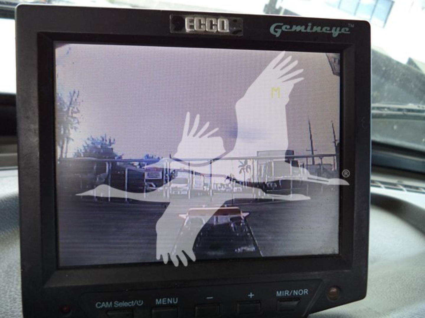 Ecco GeminEye monitor in cab showing reflection of vehicles in lot.