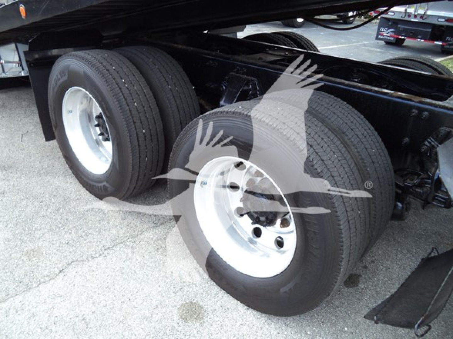 Peterbilt 348 truck rear dual axle wheels and suspension, metal dual tires and rims, undercarriage view.