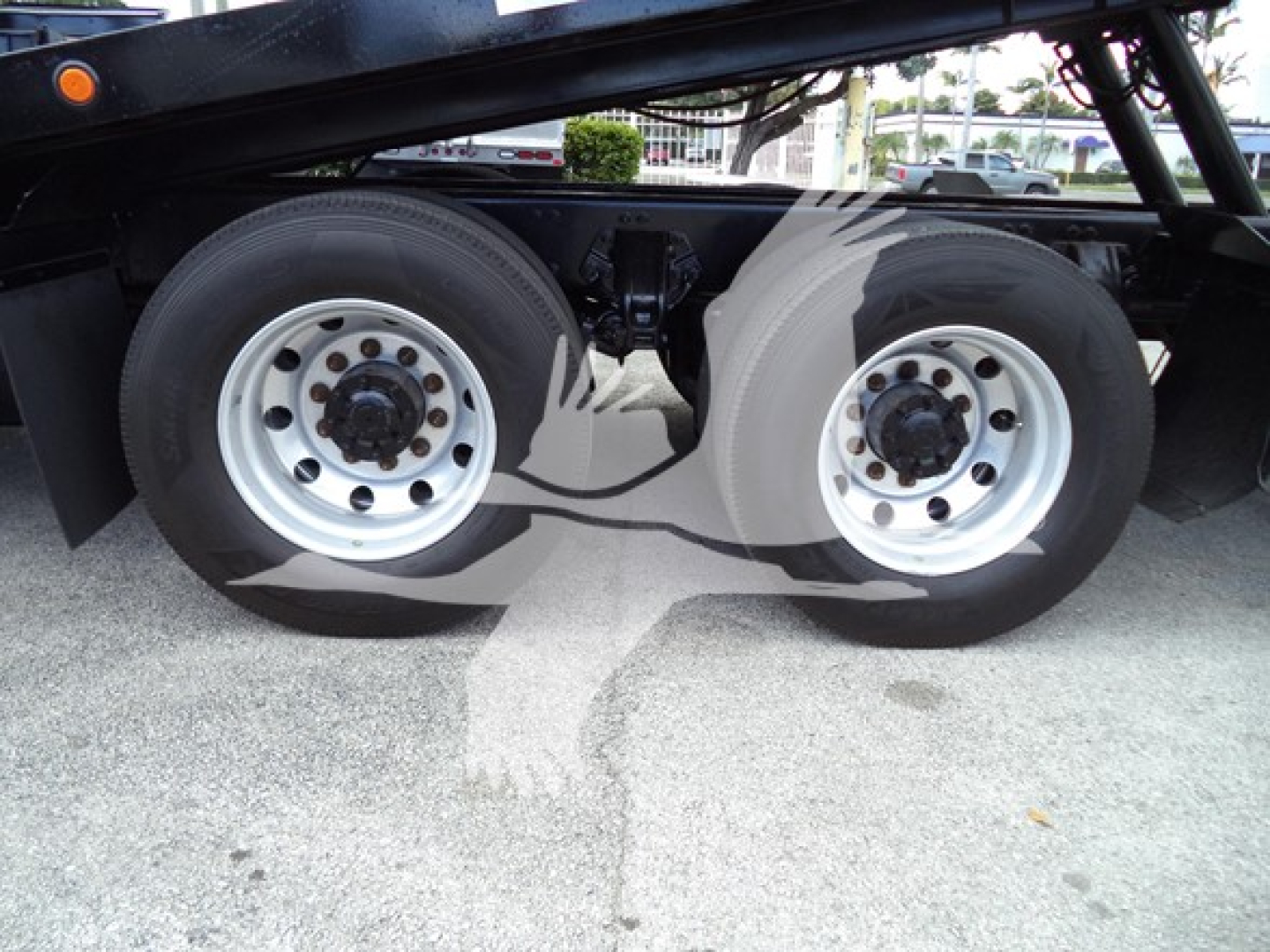 Peterbilt 348 rollback truck dual rear wheels showing concrete rims and drive axles.