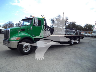 Green 2016 Peterbilt 348 rollback truck in profile view with flatbed. Visible details: front grille, dual exhaust, chrome mirrors, two-axle rear, wheel tires, and side steps.
