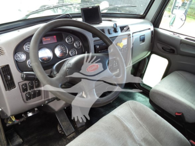 Peterbilt truck cab interior dashboard with steering wheel, gauges, and center console; visible text on instrument cluster and dash.