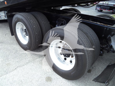 Peterbilt 348 truck rear dual axle wheels and suspension, metal dual tires and rims, undercarriage view.