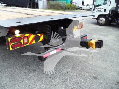 Peterbilt 348 rollback truck hitch and platform showing rear undercarriage, safety reflective chevrons, and yellow hitch pin.