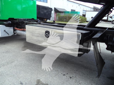 Peterbilt 348 rollback truck undercarriage showing storage box and wiring harness with green fuel tank visible.