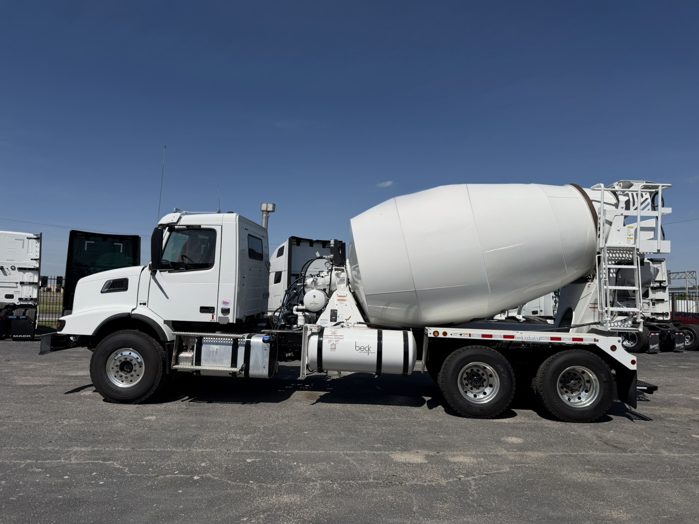 Volvo VHD64B300 mixer truck shown in side view with concrete mixer drum and chassis details visible.