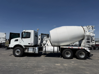 Volvo VHD64B300 mixer truck shown in side view with concrete mixer drum and chassis details visible.