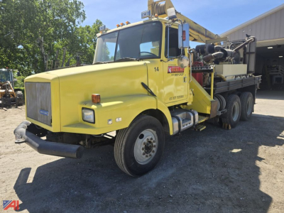 GMC WG Core Bore Drill Truck in yellow showing cab and derrick with mounted equipment on flatbed; front bumper and headlights visible.