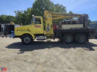 GMC WG core bore drill truck side view showing yellow boom crane and drill rig on long dual rear axle.