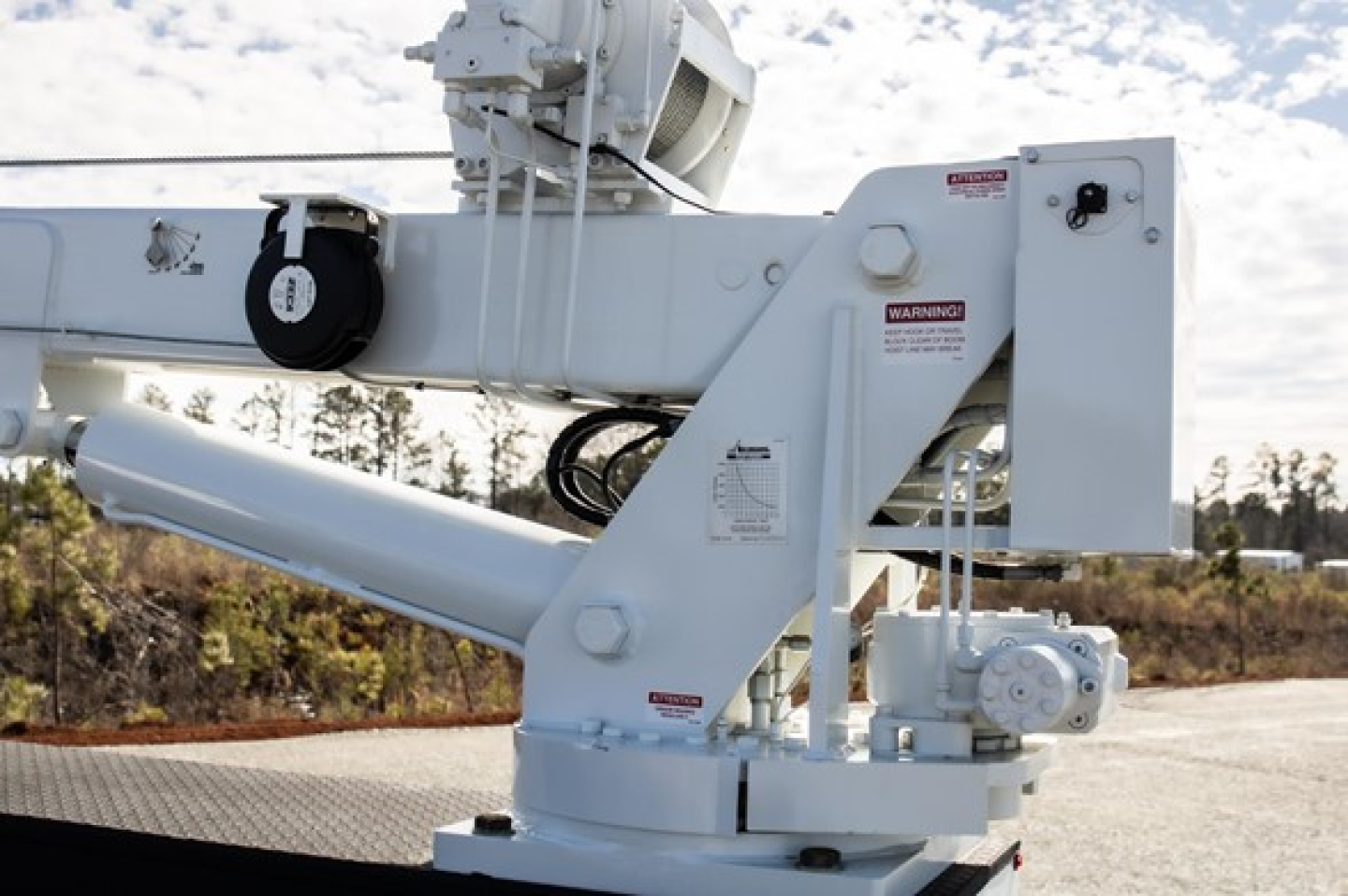Freightliner M2 106 Plus service truck crane/boom component with hydraulic arm and warning labels visible.