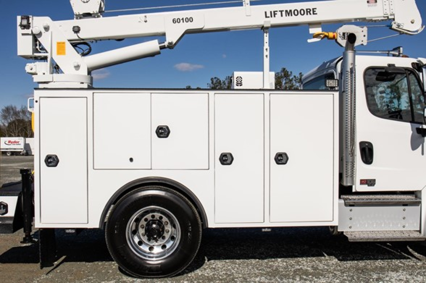 Freightliner M2 106 plus service truck side view with utility compartments and utility body