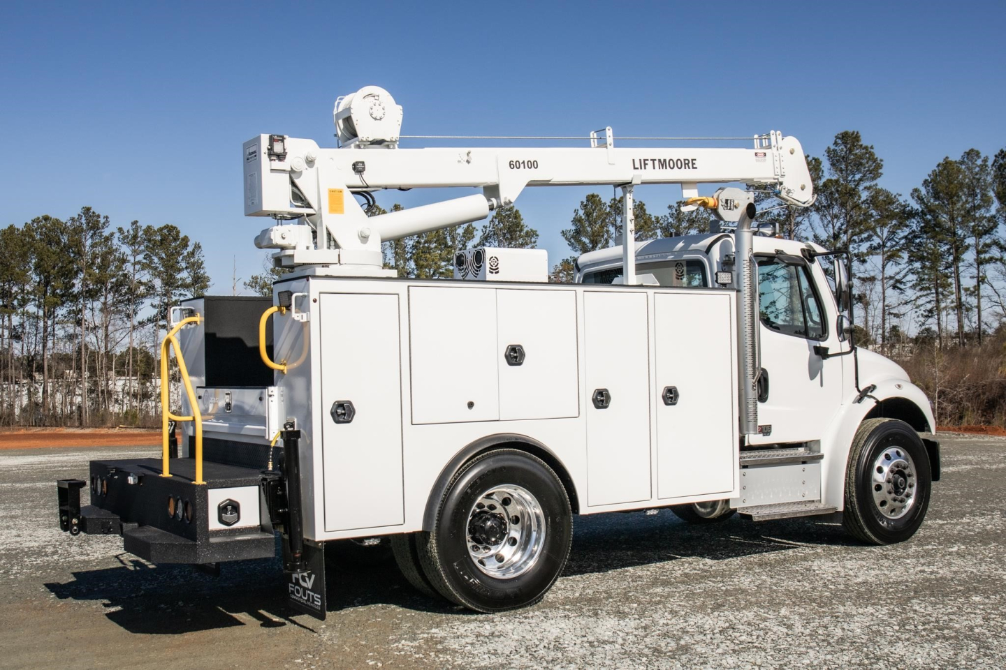 Truck body of a 2025 Freightliner M2 106 Plus service utility vehicle with a mounted boom; side compartments, chrome wheels, and LiftMoore crane labeled 60100 visible.