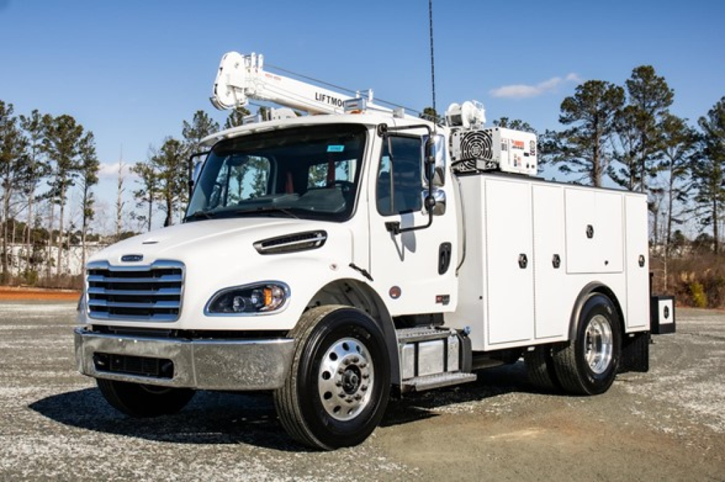 Service/Utility truck showing a 2025 Freightliner M2 106 Plus with utility cabinets and a crane on the cab, white paint and chrome bumper.