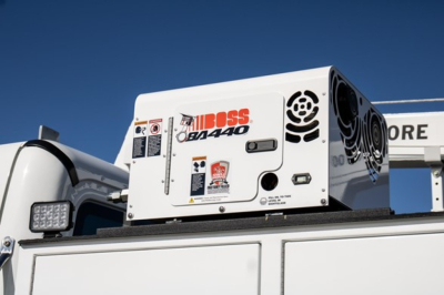 Freightliner M2 106 Plus service truck equipment: portable generator unit labeled JOBOSS QF1440 mounted on truck bed with control panel and safety stickers.