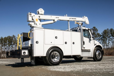 Freightliner M2 106 Plus service truck with aerial bucket in white, side storage compartments, ladder rack, and lift boom extended.