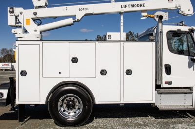 Freightliner M2 106 plus service truck side view with utility compartments and utility body