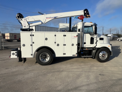Service/utility truck with a crane boom mounted on service body, side view showing compartments and Steps, Mack MD6 in white