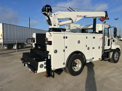 Service/utility truck with crane, white utility body, multiple compartment doors, rear stowage, and mounted crane on top of the truck bed.