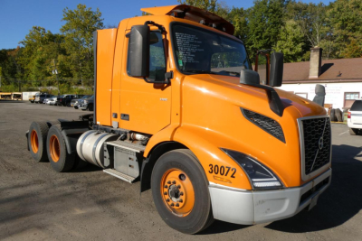 Volvo VNR64T300 daycab truck in orange, front three-quarter view, showing 30072 on fender and 6x4 rear wheels.