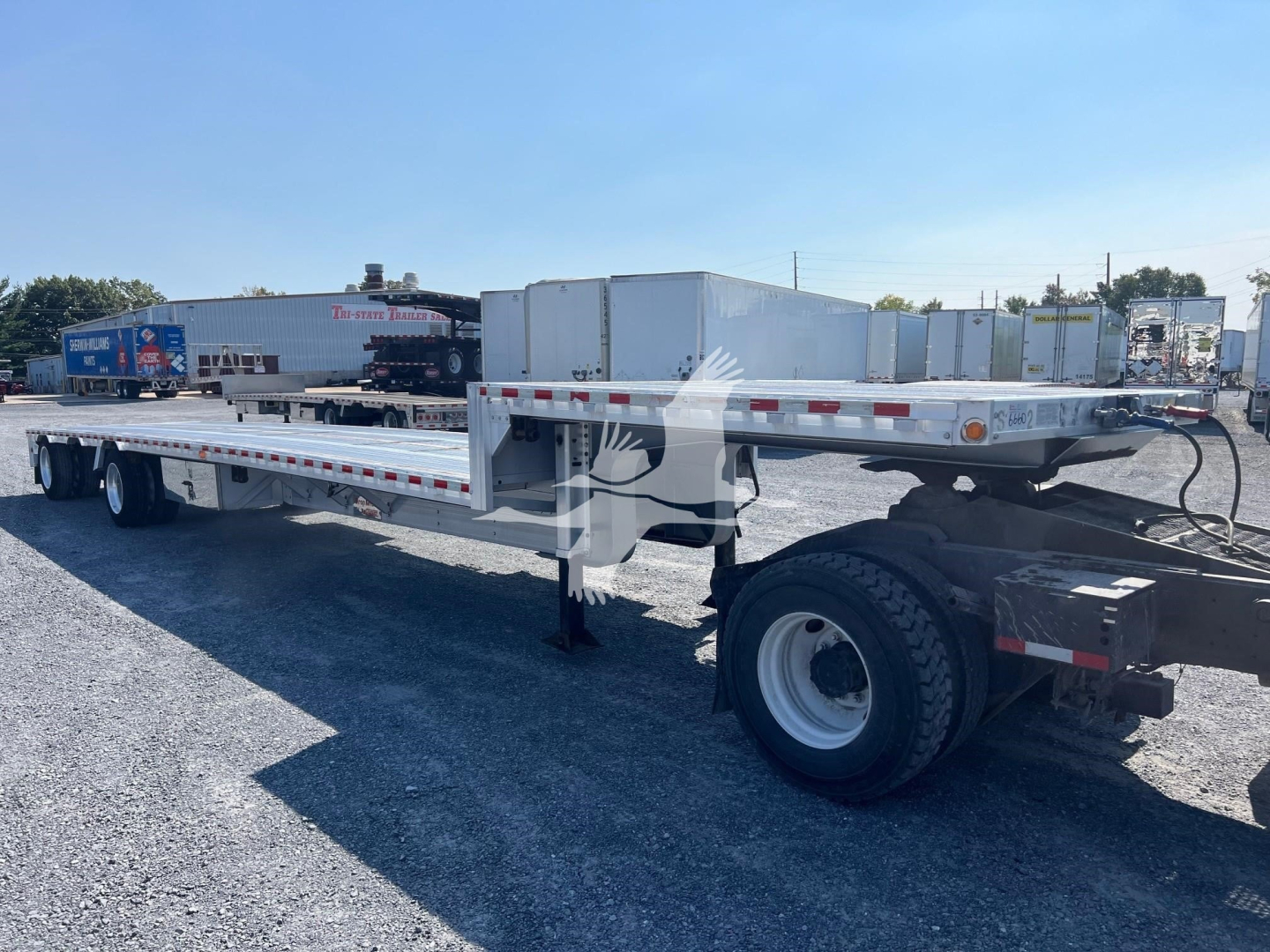 2019 Reitnouer Dropmiser trailer side view showing flatbed with dual rear axles and toolbox; VIN 1RND48A23KR045076 and stock 7664 not visible on image but context provided.