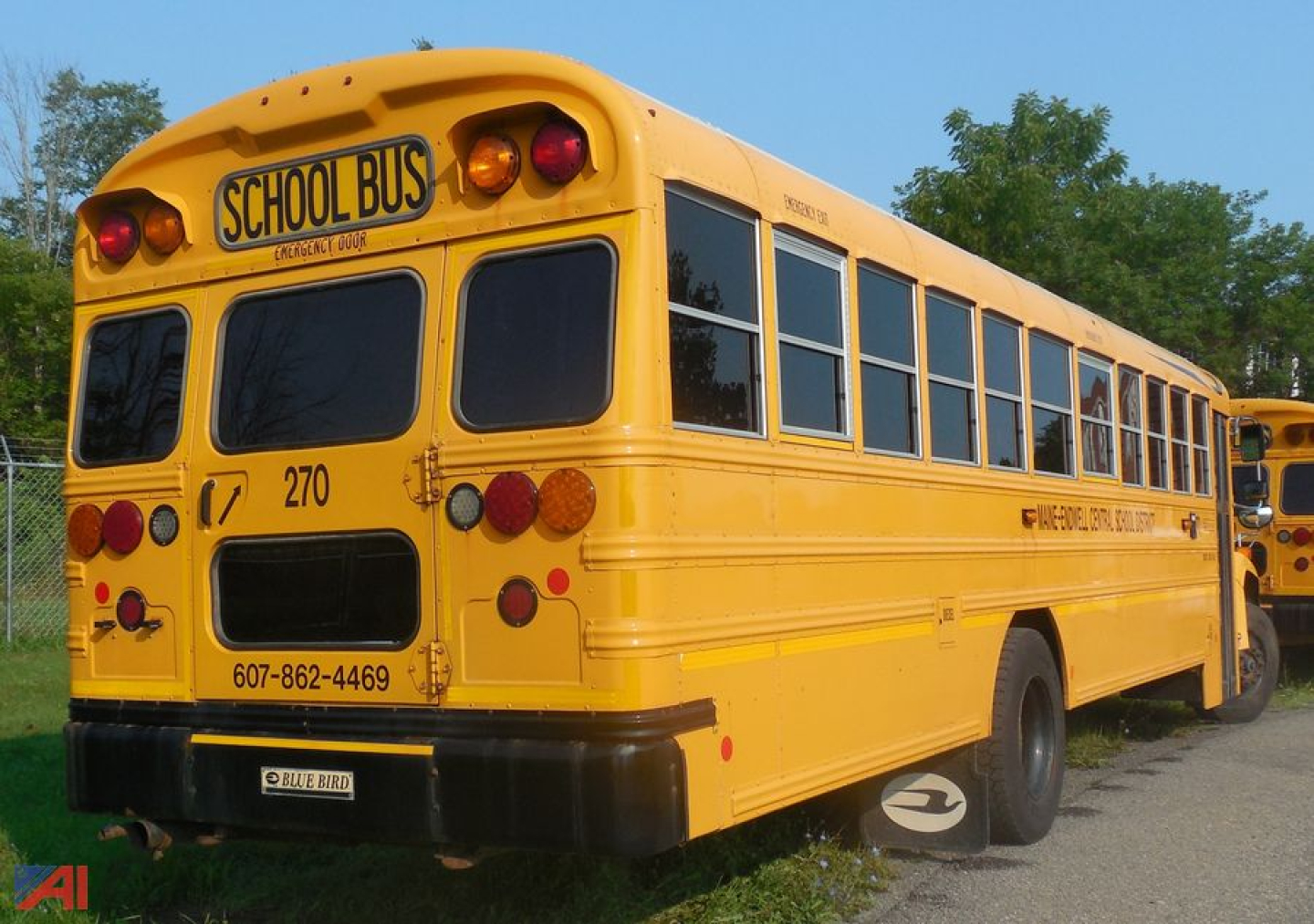 Yellow 2018 Blue Bird Vision school bus rear three-quarter view showing SCHOOL BUS sign, rear taillights, and side windows.