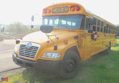 Yellow 2018 Blue Bird Vision school bus side view showing front grille, stop sign, and school bus text on hood and windows.