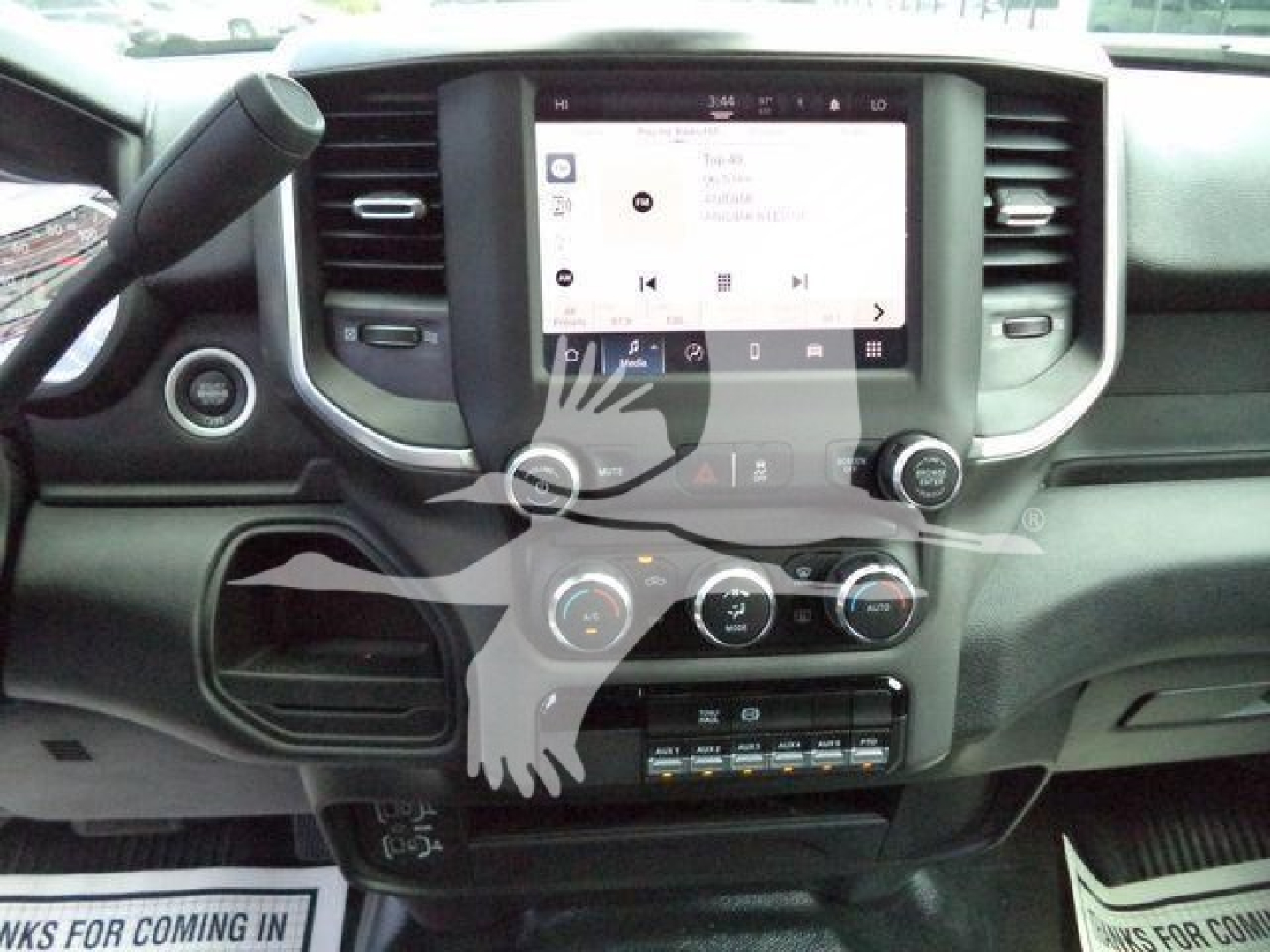 Ram 5500 interior dashboard showing center touchscreen infotainment system, climate controls, and gear selector area.