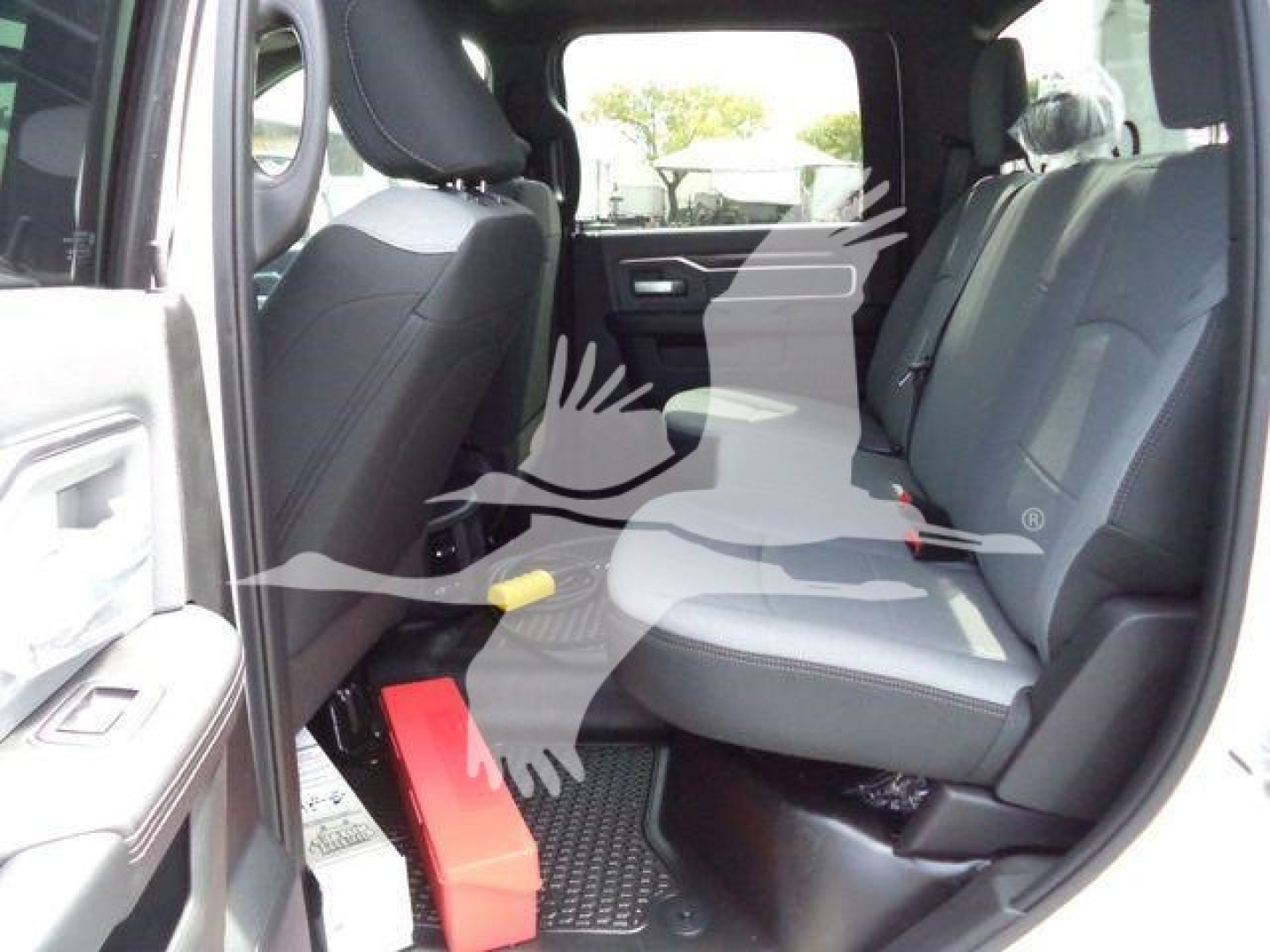 Ram 5500 SLT interior, front and rear seats visible, showcasing cabin with gray cloth seats and black door panels.