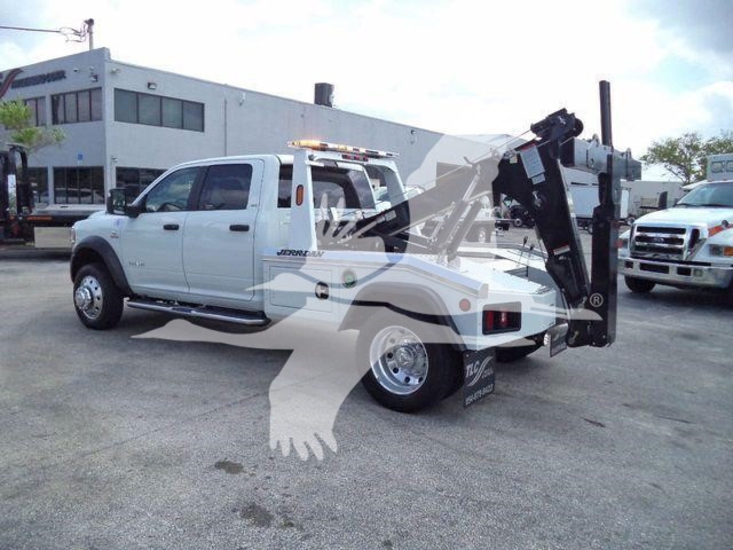 Ram 5500 tow truck with crane/boom in white, side view showing stake cab and rear equipment mount